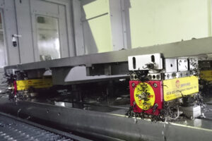 close-up of magnetic vise blocks holding large flat metal sheet inside cnc machine